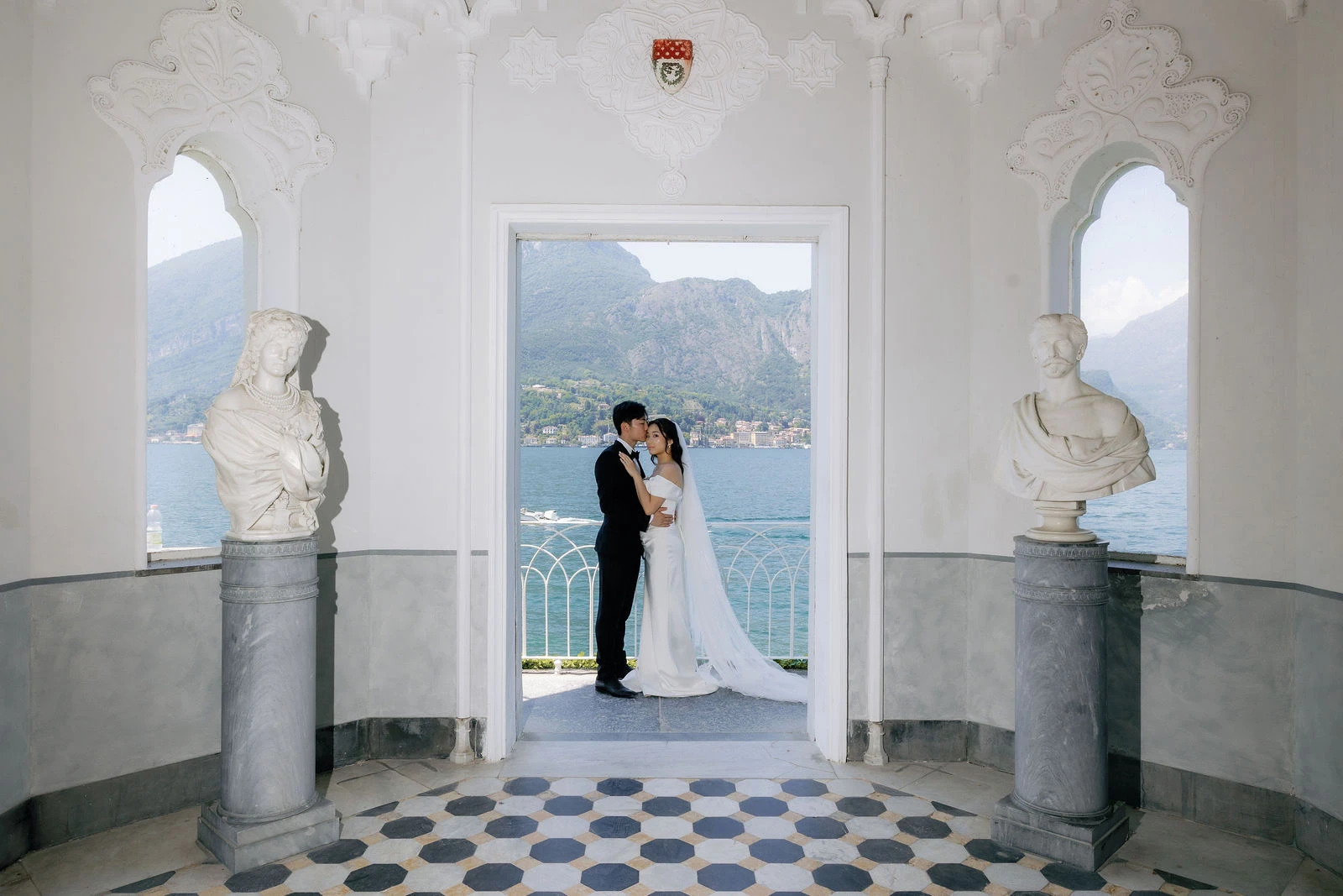 Couple in a lakeside pavilion with marble busts at Villa Melzi, Lake Como