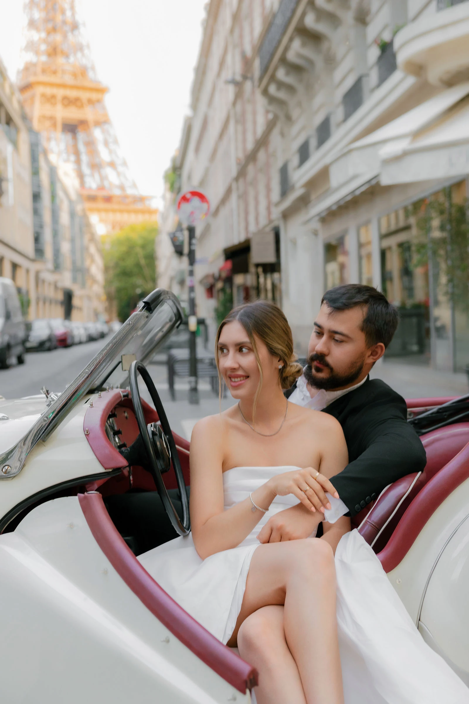 Anatoly and Julia in a white vintage roadster, Paris