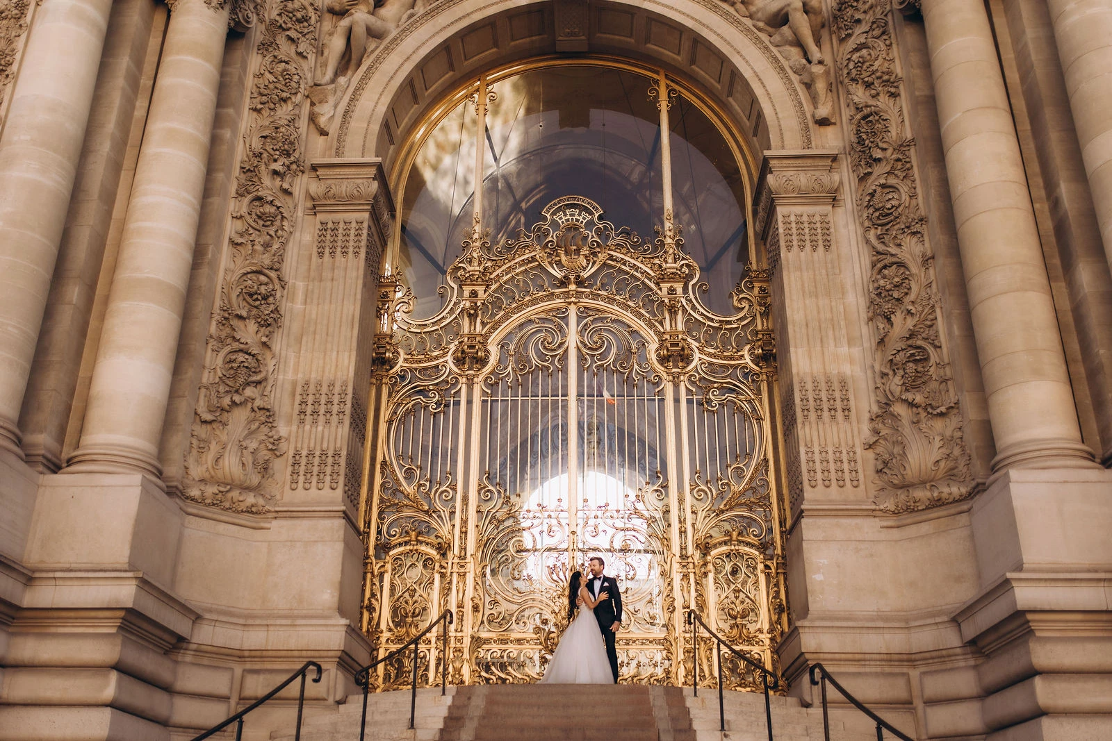 Couple before the golden gates of the Petit Palais, Paris