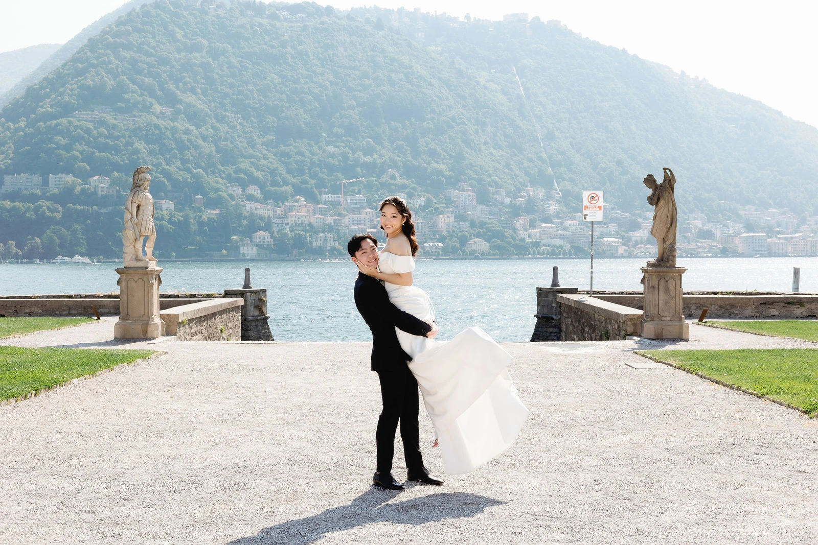 Groom lifting the bride on the Como lakefront