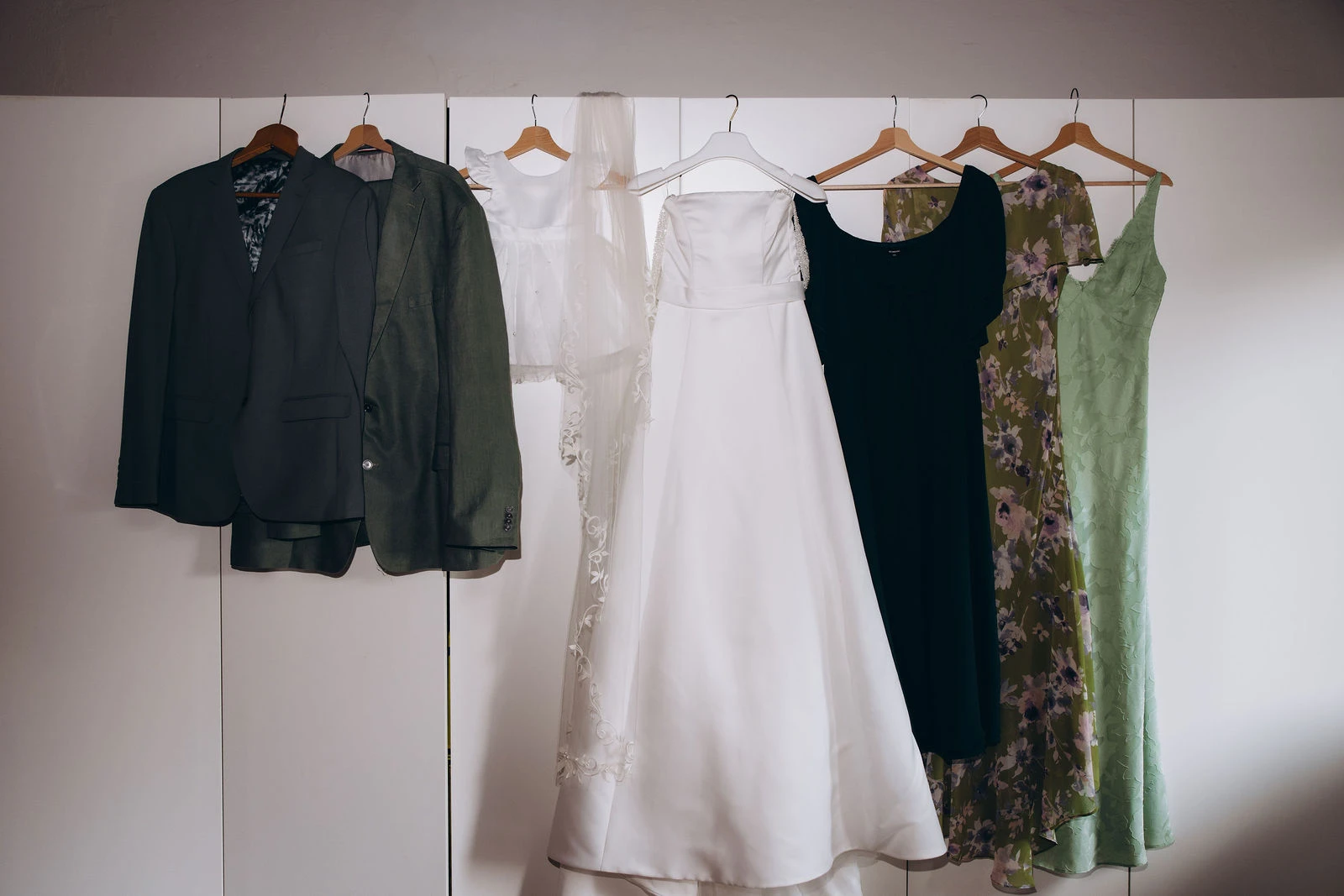 Wedding outfits hanging side by side before getting ready