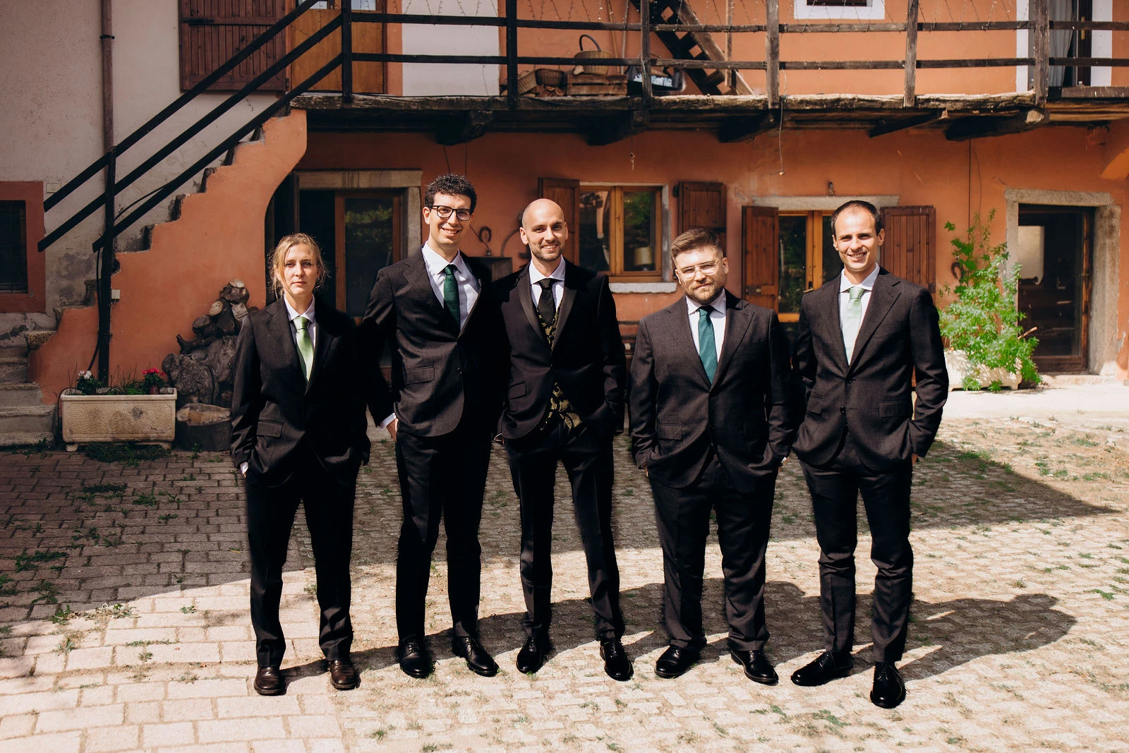 Groom and groomsmen lined up in the villa courtyard