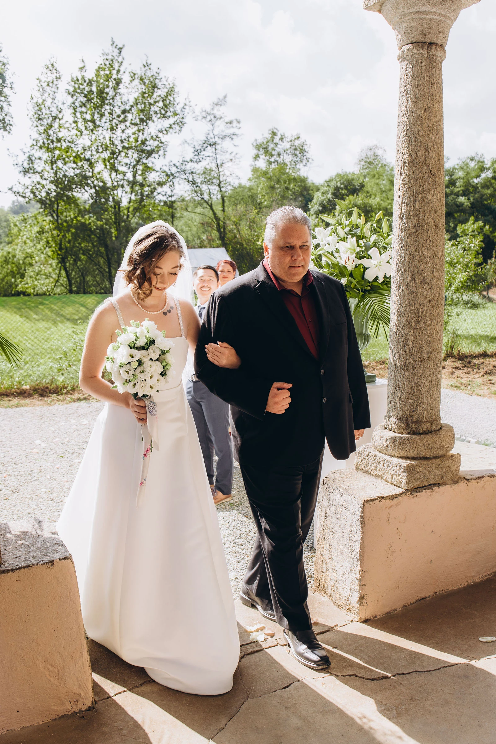 Father walking the bride to a small Italian church