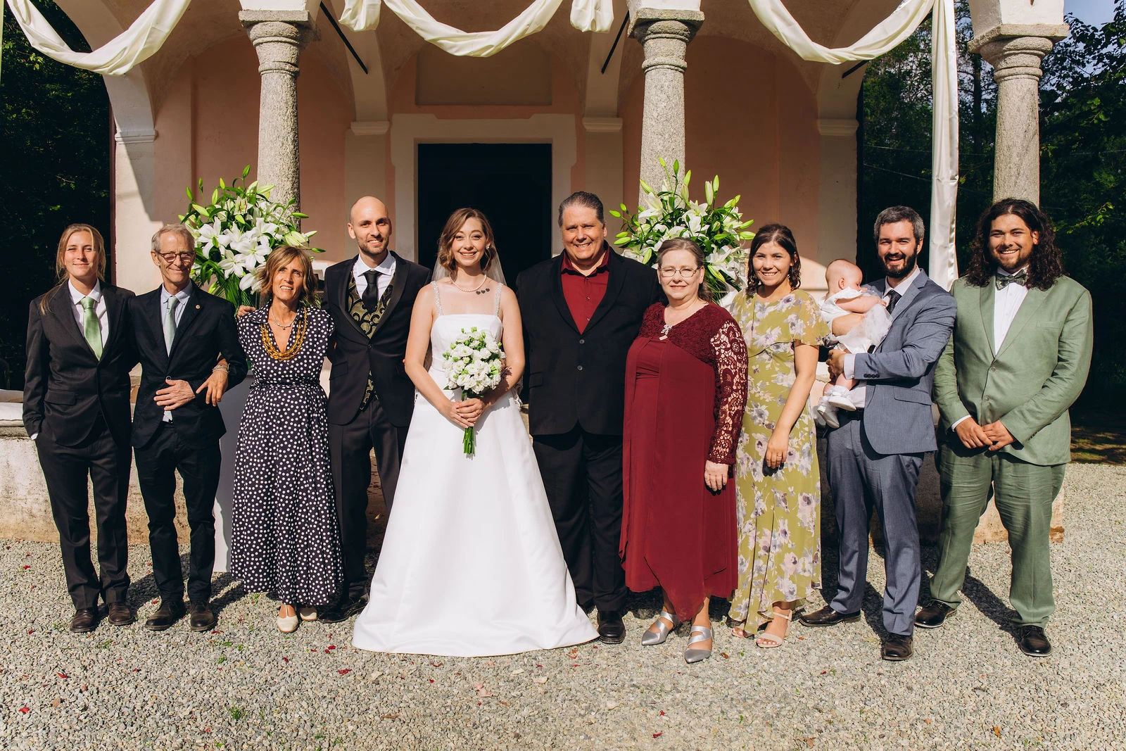 Family group by the church arcade after the ceremony