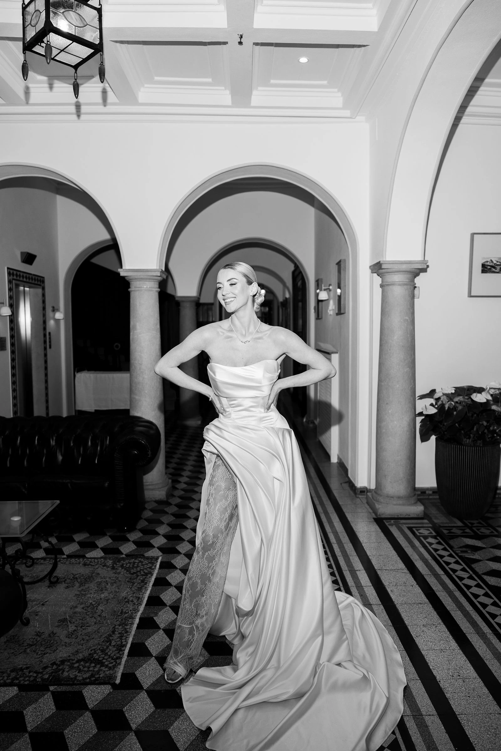 Bride under the arches on a checkerboard floor