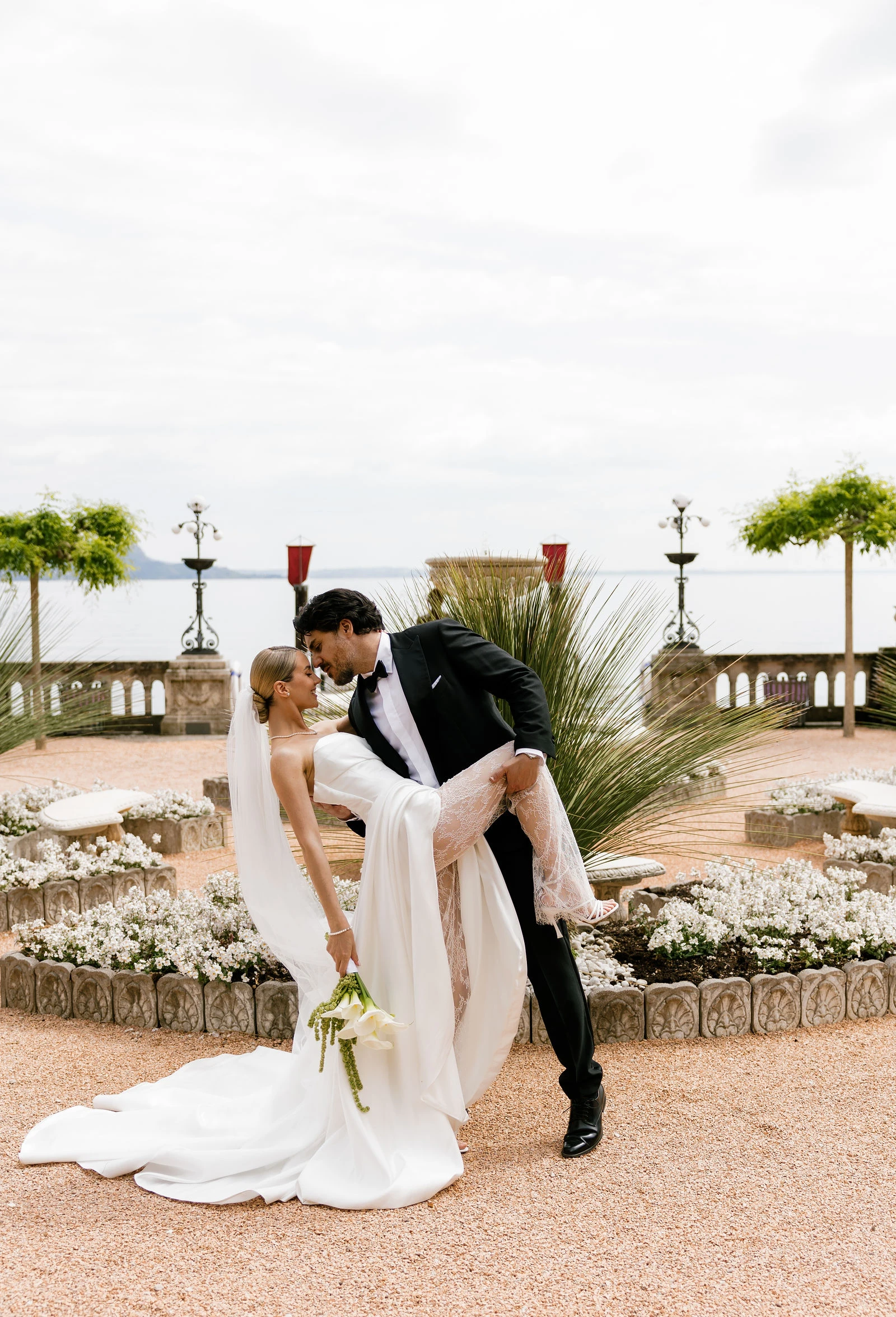 Groom dipping the bride in the hotel garden