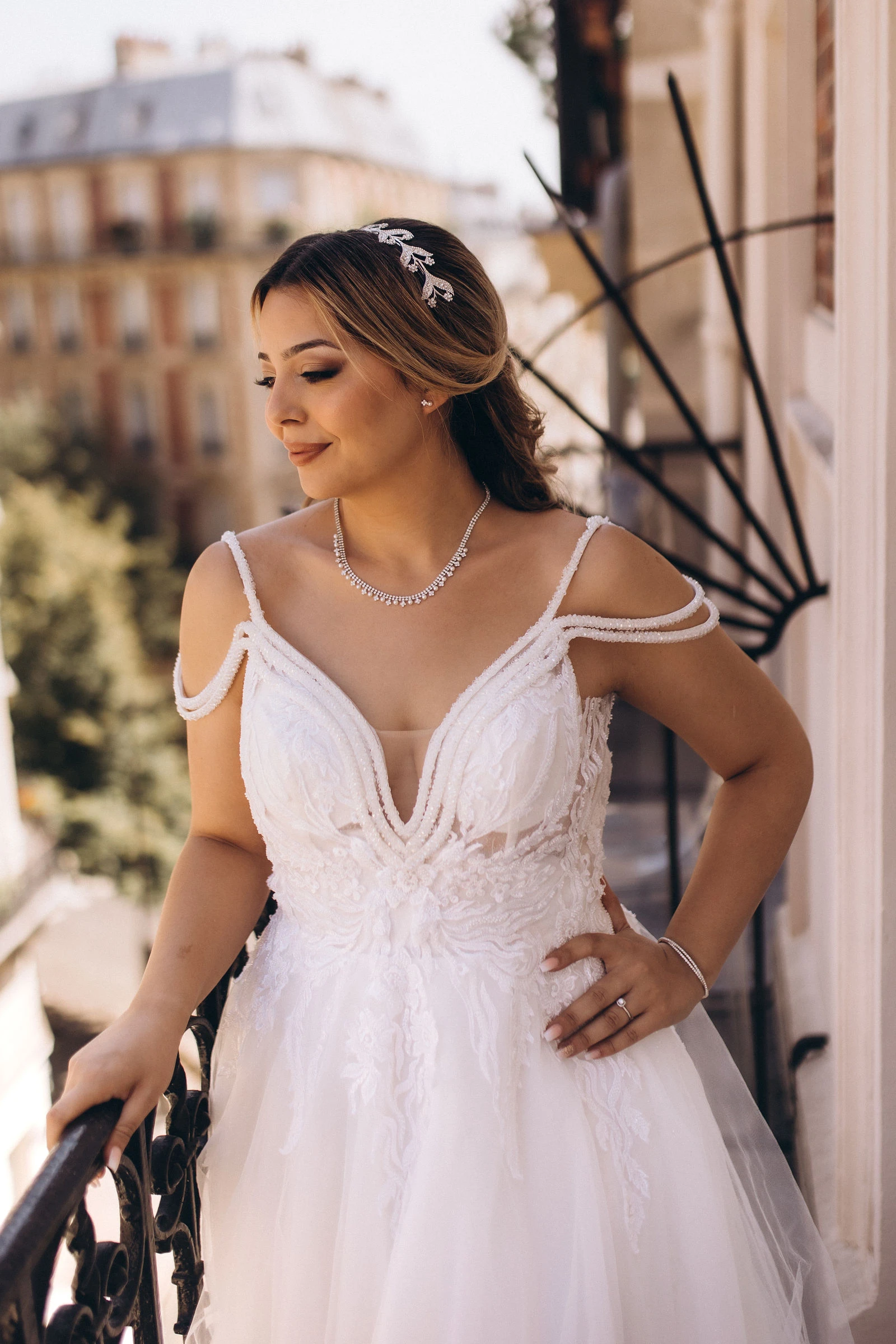 Bride on the balcony with Paris rooftops behind