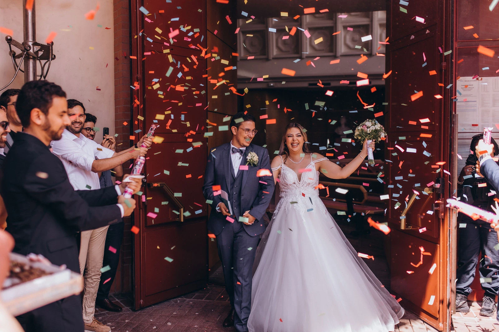 Guests throwing confetti as the couple leave