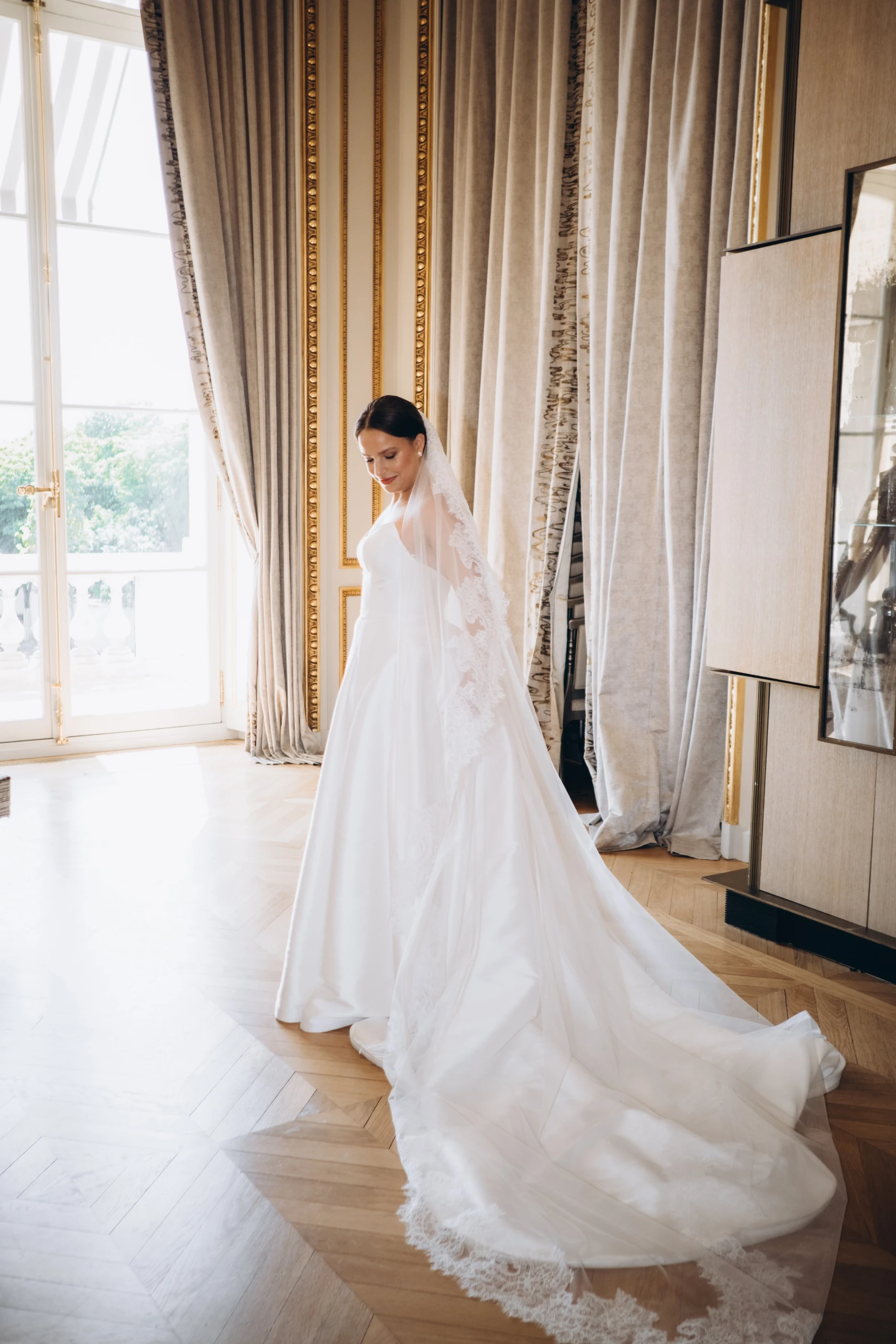 Bride in her dress in a gilded salon