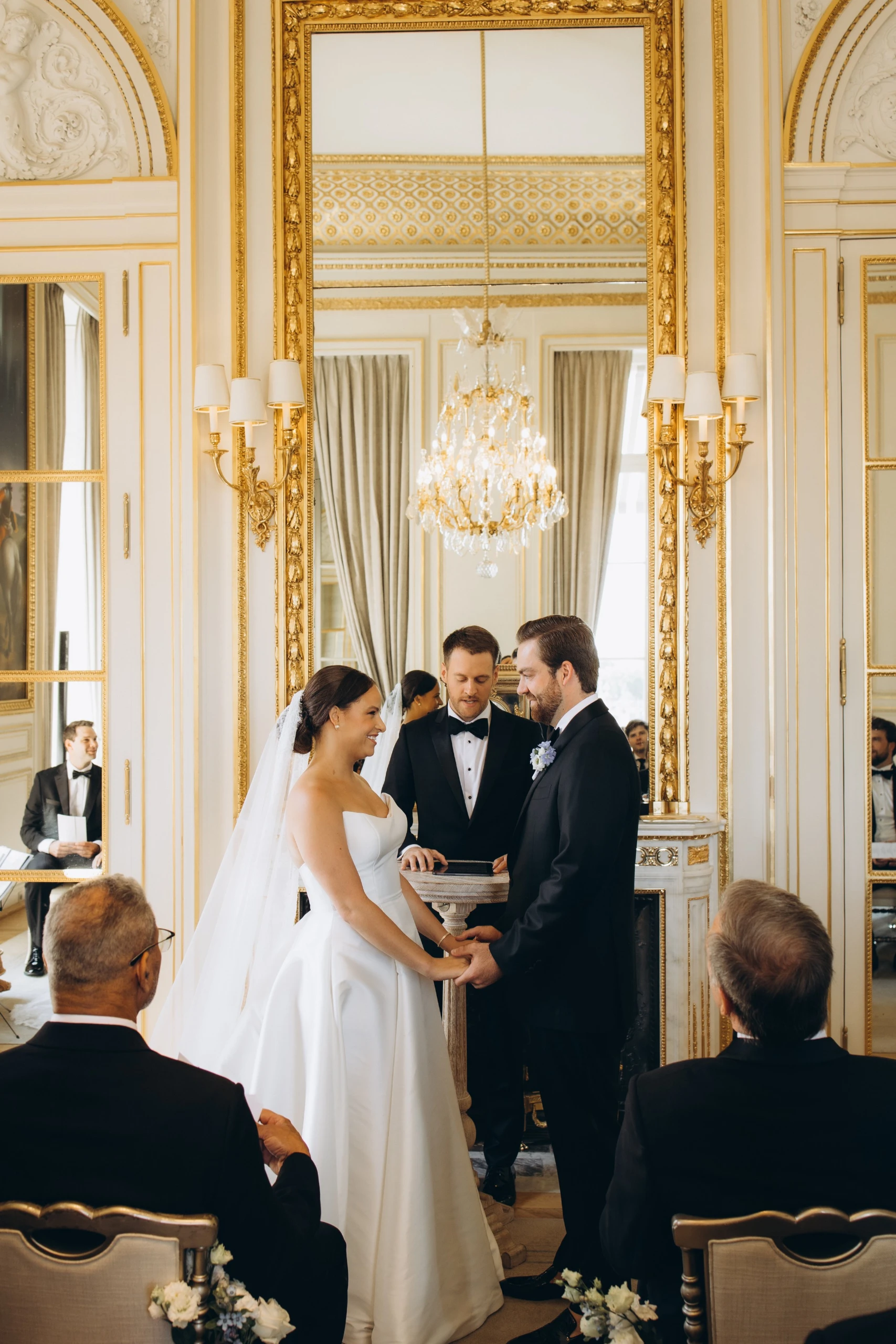 Ceremony in a gilded salon under chandeliers