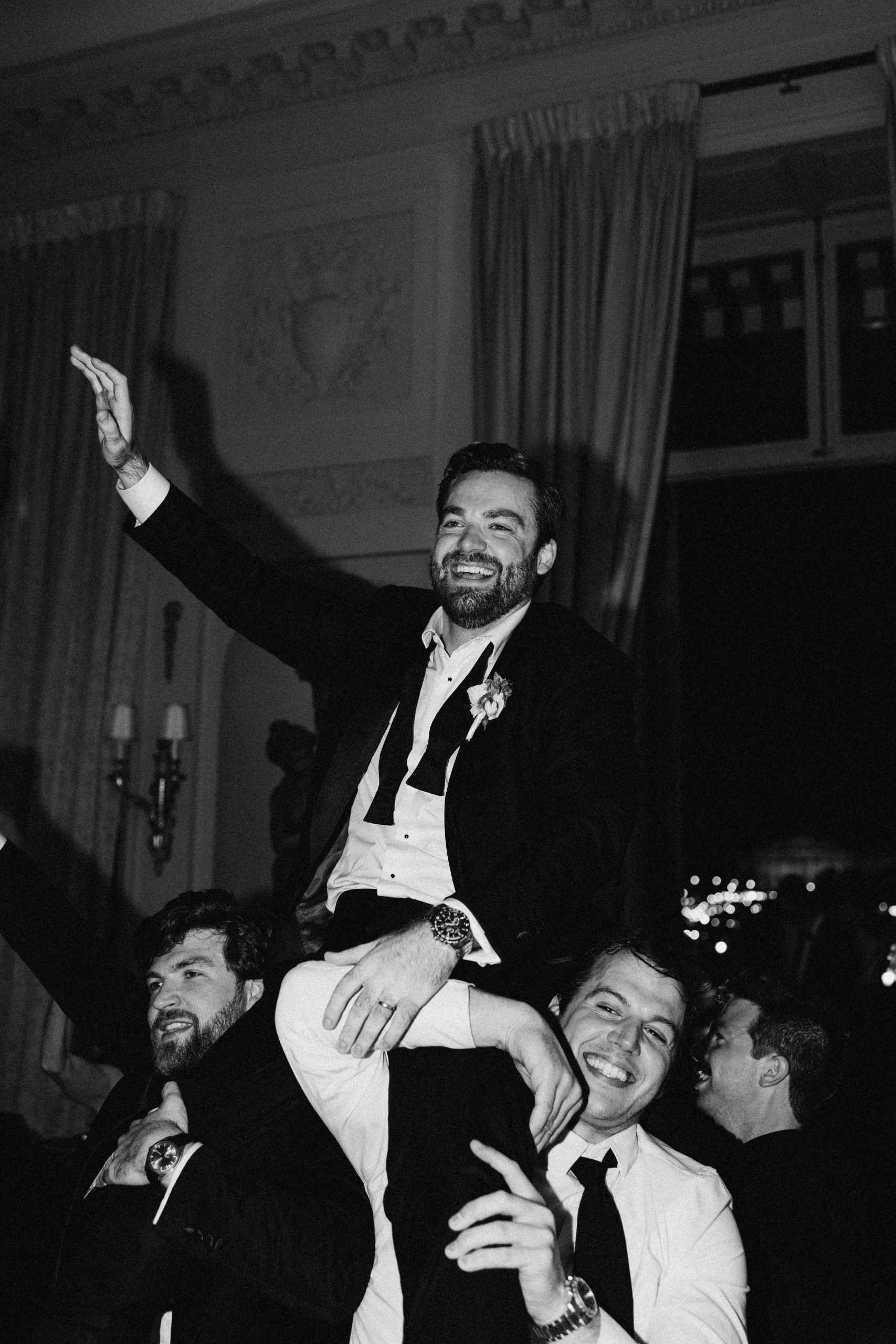 Groom lifted by his friends on the dance floor