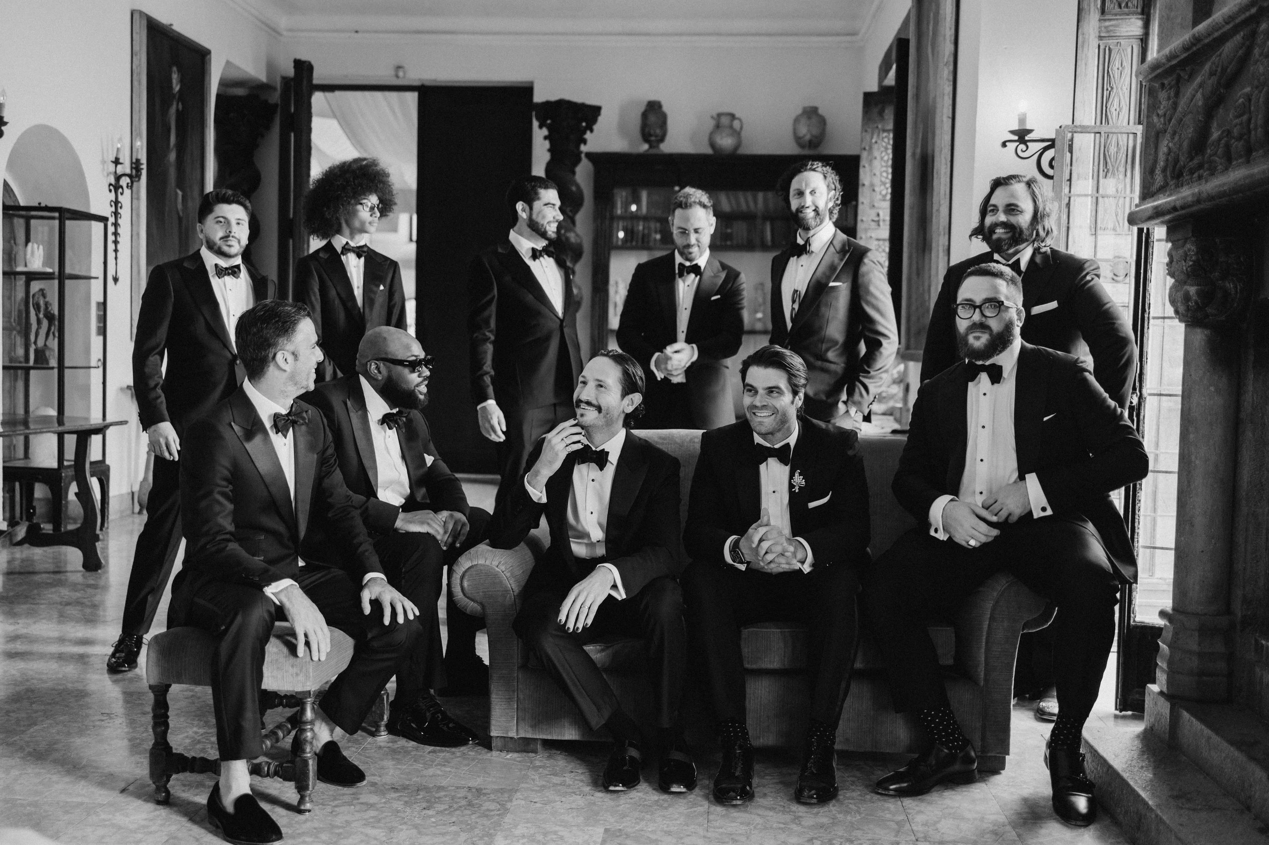 Groom and groomsmen in a castle library, black and white