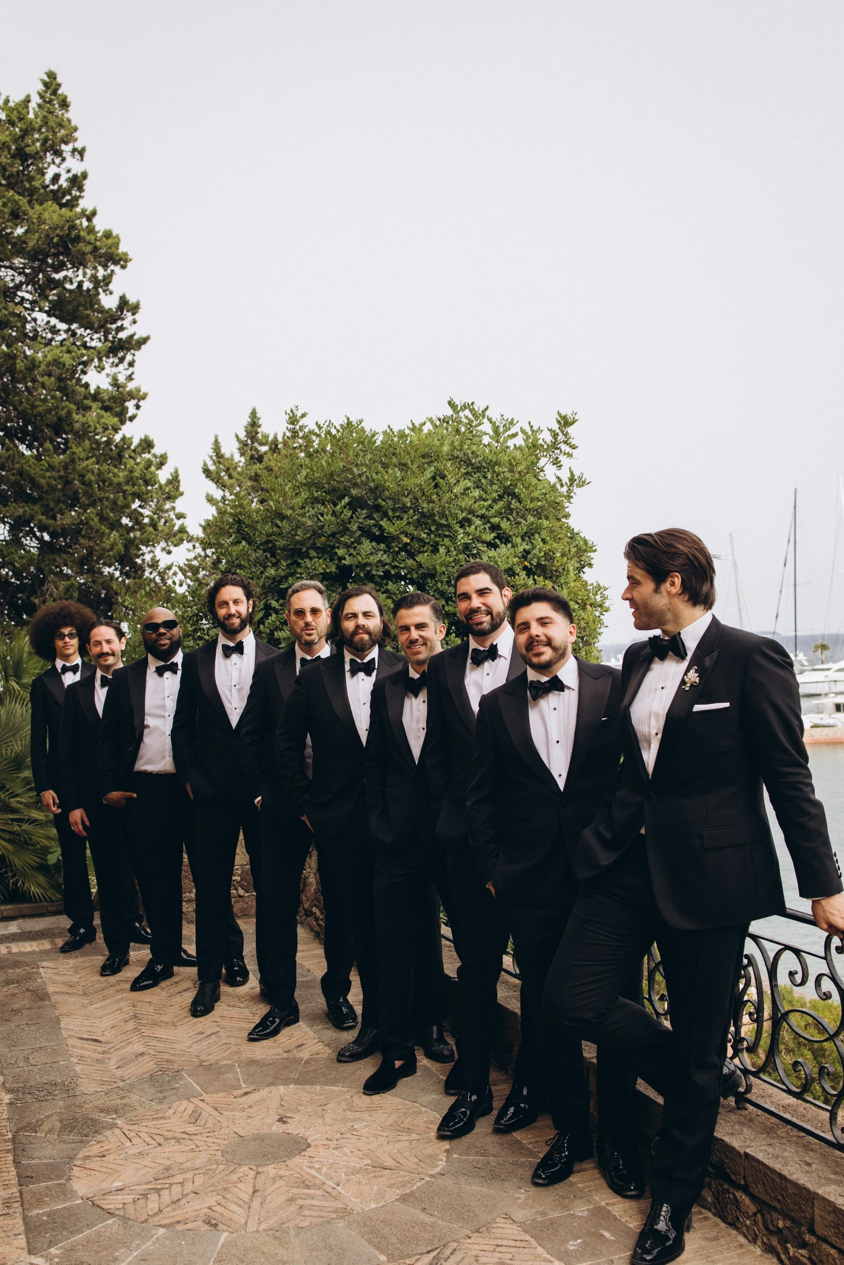Groomsmen on the castle terrace above the sea