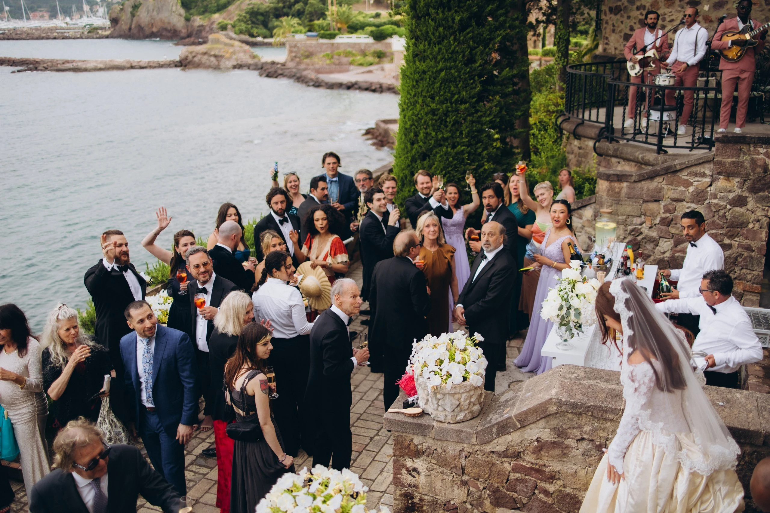 Guests gathered on the terrace by the sea