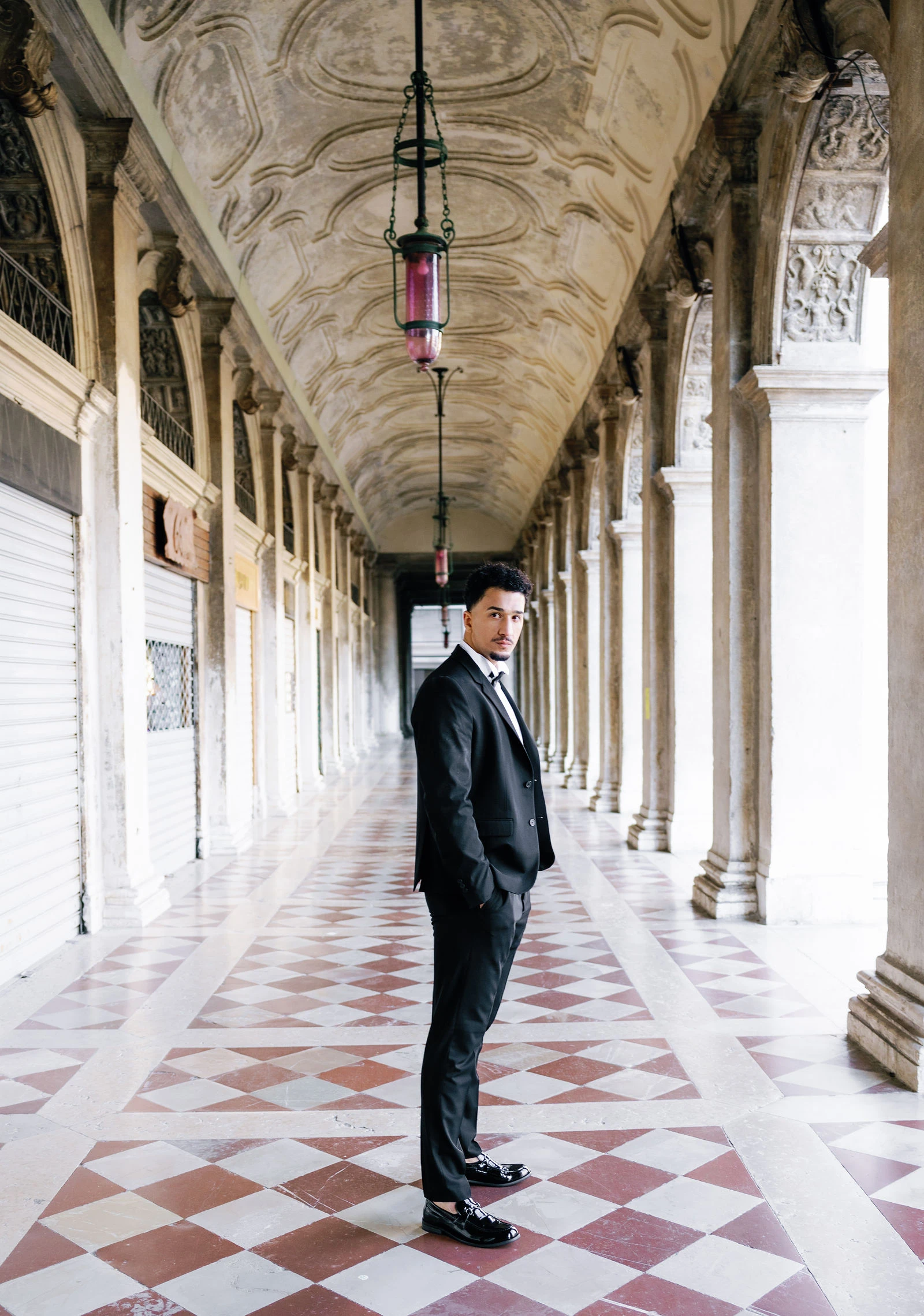 Groom in the arcade with a checkerboard floor, Venice