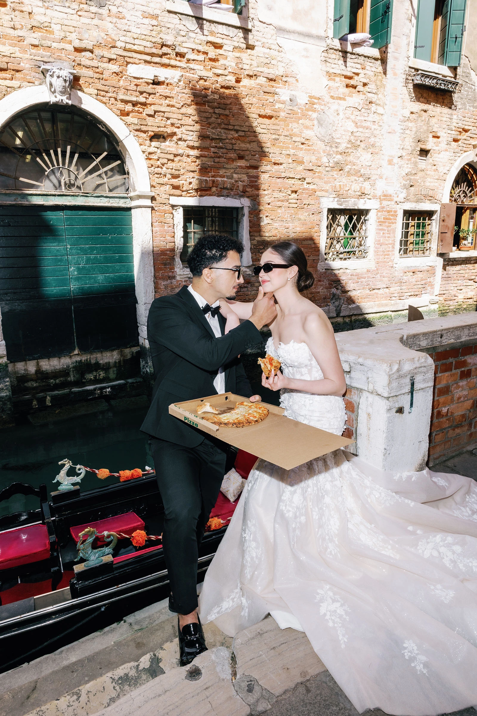 Pizza break by a gondola landing, Venice