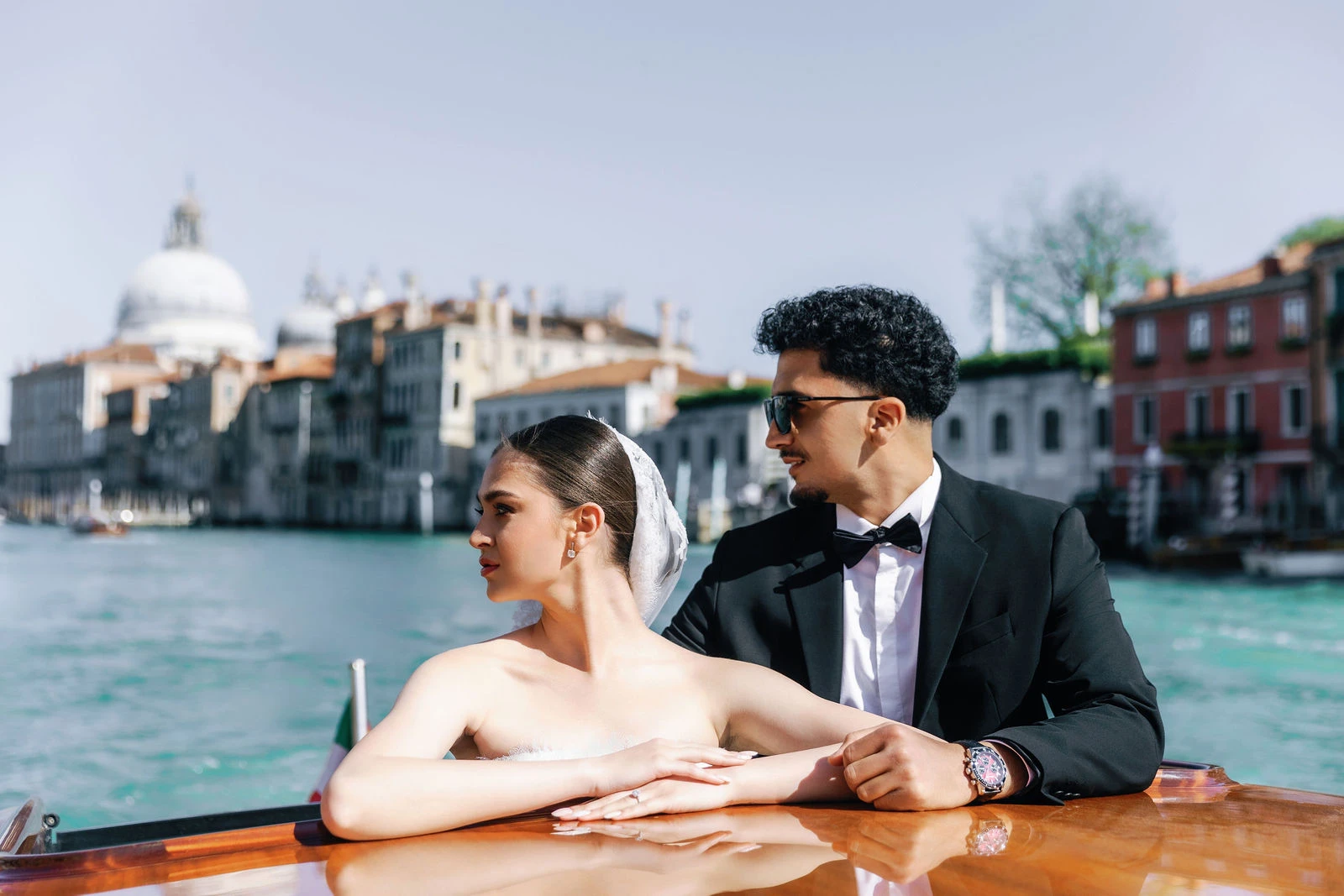 Couple on a water taxi passing the Salute