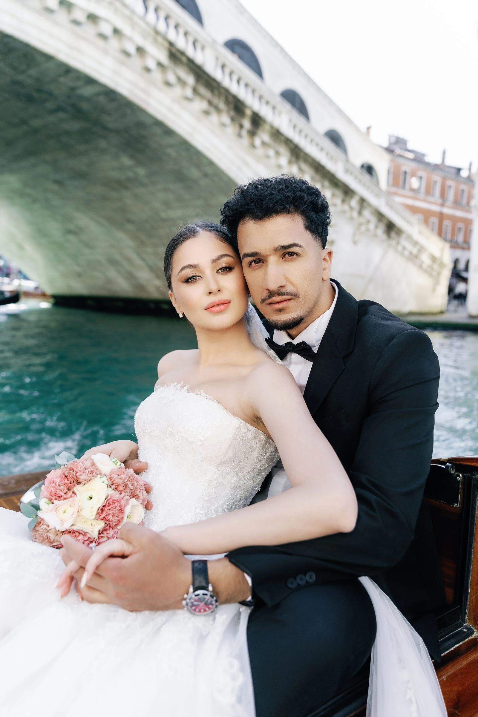 Couple on a water taxi under the Rialto Bridge