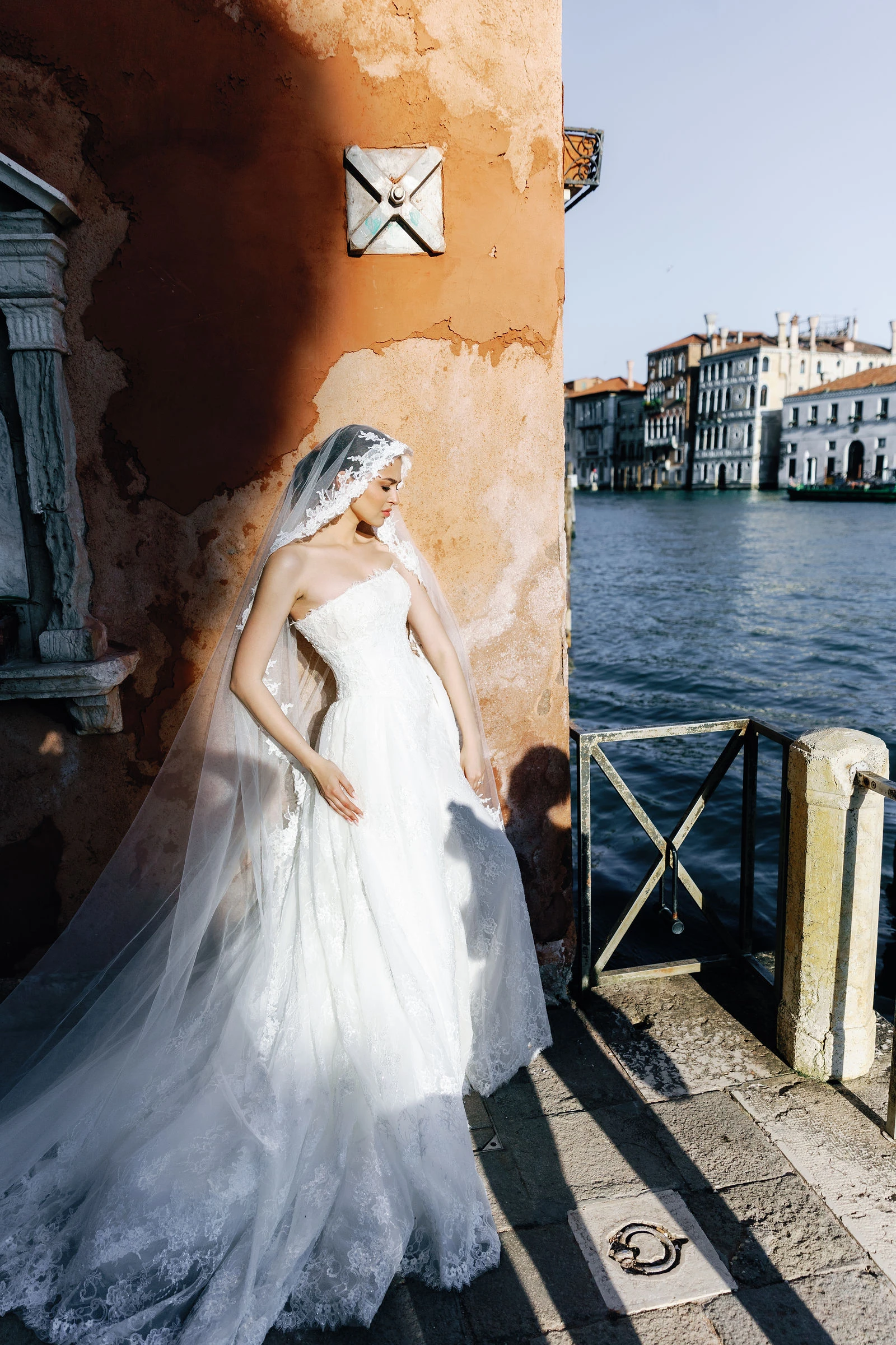 Bride against an orange wall on the Grand Canal