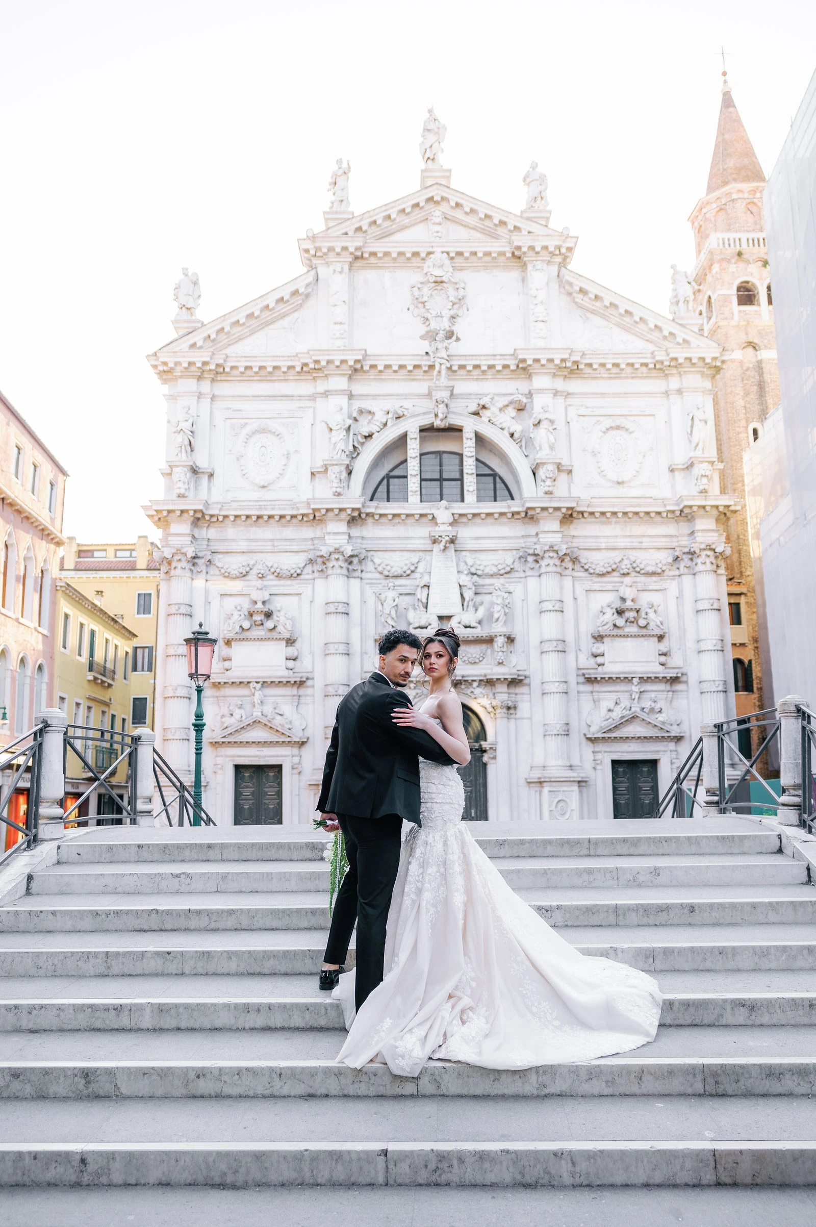 Couple on the white marble steps of a Venetian church
